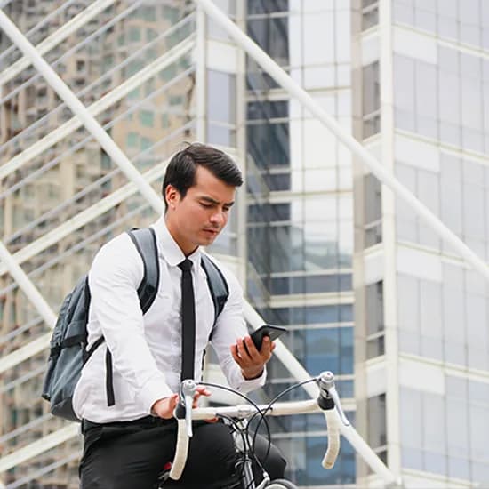 Business commuter reviewing an invoice approval notification on his phone