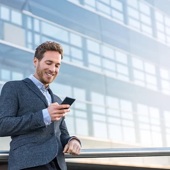 Manager approving a purchase order on his phone outside an office