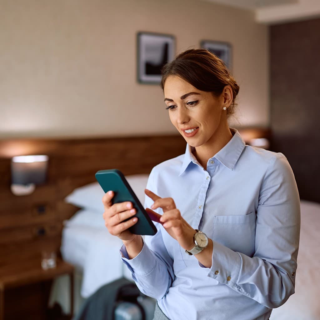 Business traveller submitting an expense claim on her phone