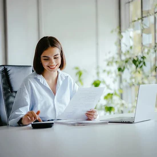 Hospice finance administrator reviewing supplier invoice documents