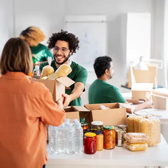 Charity volunteers packing food donations at a community support centre