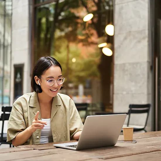 Creative arts finance team member working on a laptop outside a venue